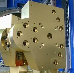 Gold-colored coated machine component with several bores