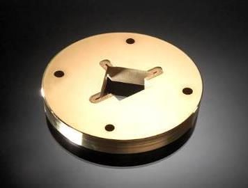 Round gold-colored coated component