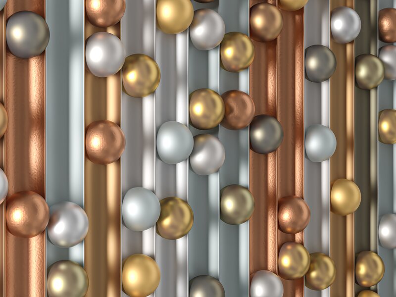 Symbolbild für PVD-Beschichtung mit mehrlagigen metallischen Schichten in Gold, Kupfer und Silber – für Design und Verschleißschutz bei RÜBIG