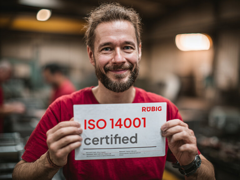 RUBIG Die Forge certified to ISO 14001 – committed to sustainability RUBIG employee holding ISO 14001 certificate – environmental and quality standards in forging operations